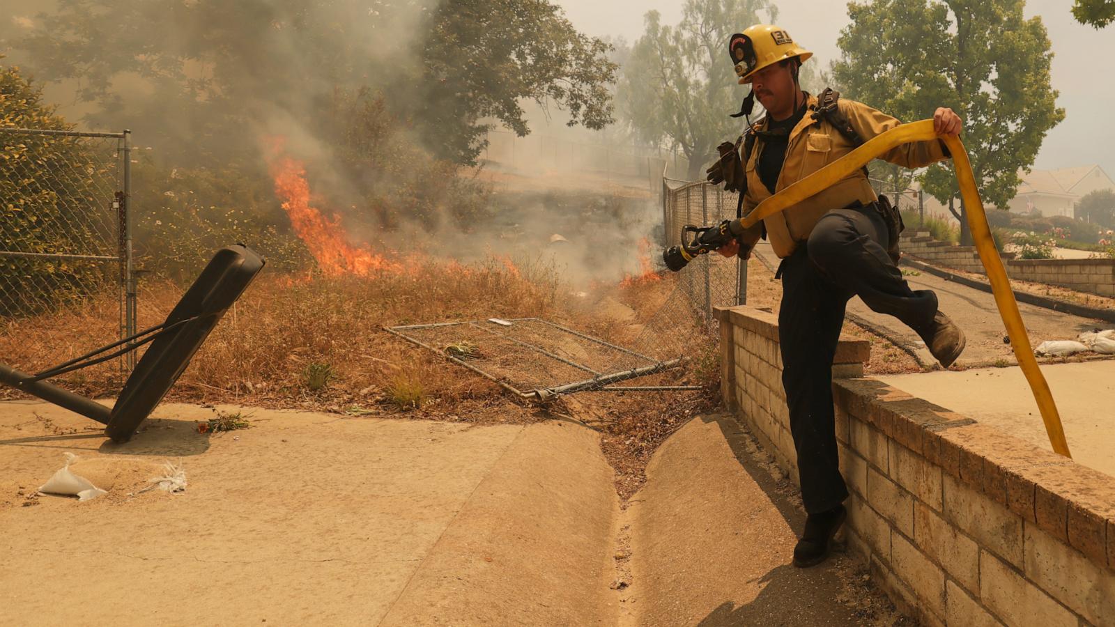 Fast-growing brush fire in Southern California threatens homes